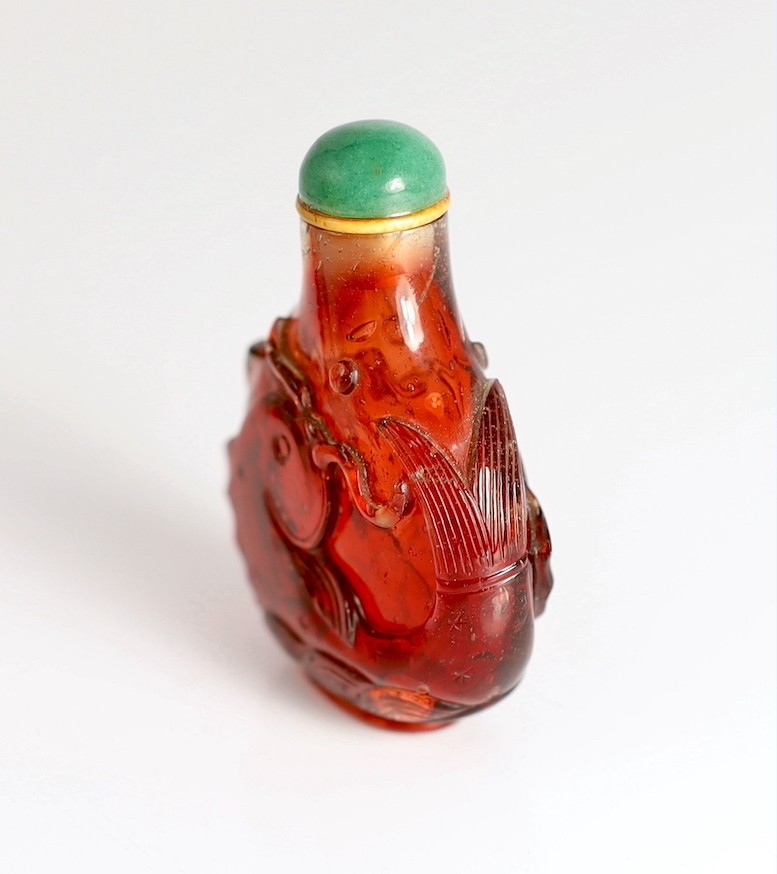 A Chinese ruby red glass ‘leaping carp’ snuff bottle, 1750-1850, 5.9cm high